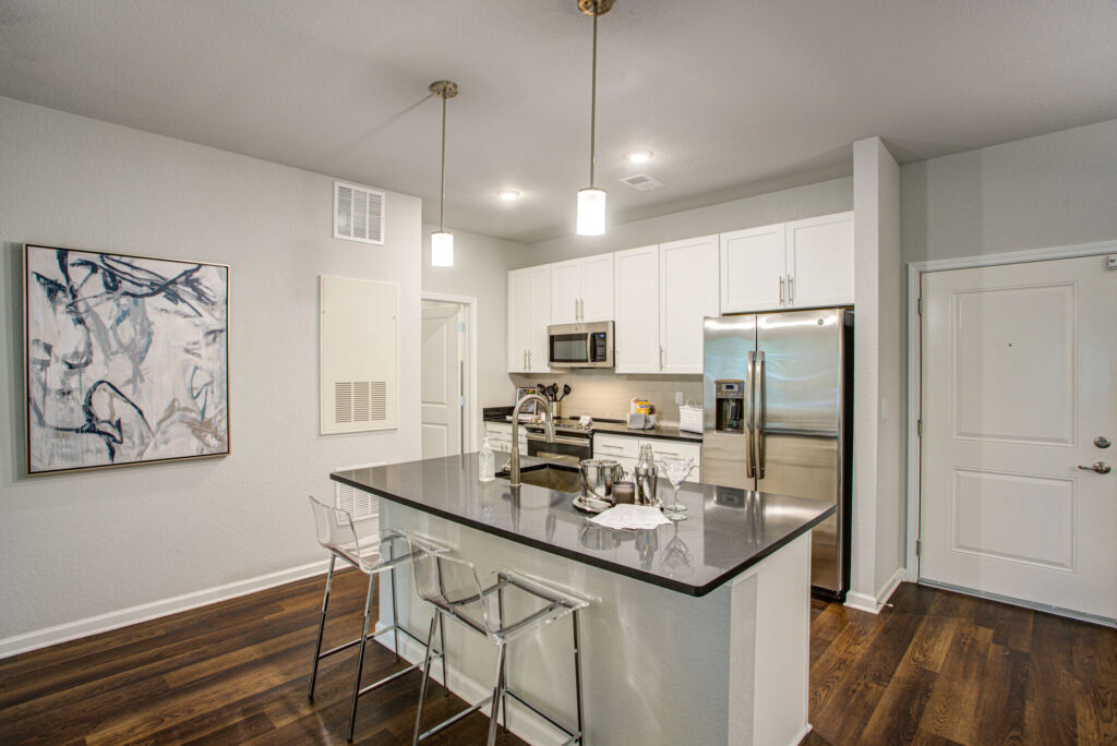 Kitchen with stainless steel appliances and black counters